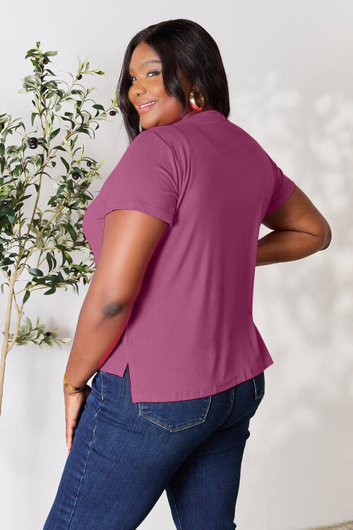 Basic Bae Full Size Round Neck Short Sleeve T-Shirt in pink, featuring a slightly stretchy, opaque fabric with a classic fit.