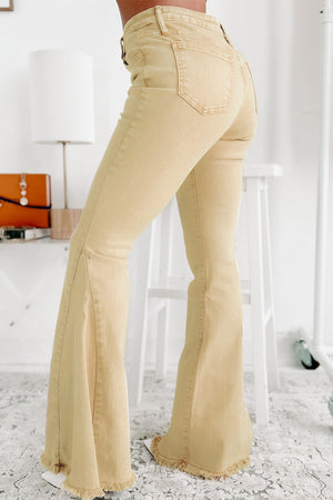 Raw edge mid waist flared jeans with pockets and raw hem in light beige.