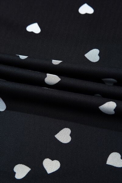Heart print detail on black semi-sheer fabric bodysuit.
