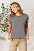 Basic Bae full size round neck short sleeve t-shirt in gray, worn by a smiling woman.