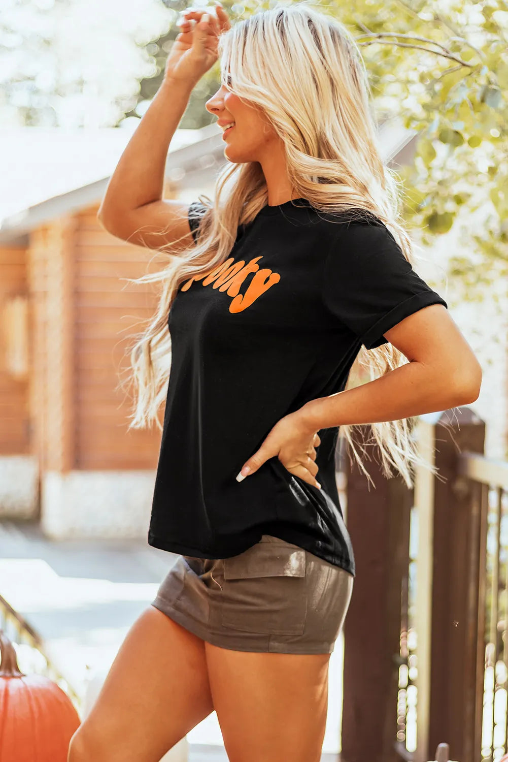 Spooky round neck short sleeve black t-shirt, slightly stretchy, worn by a person outdoors.