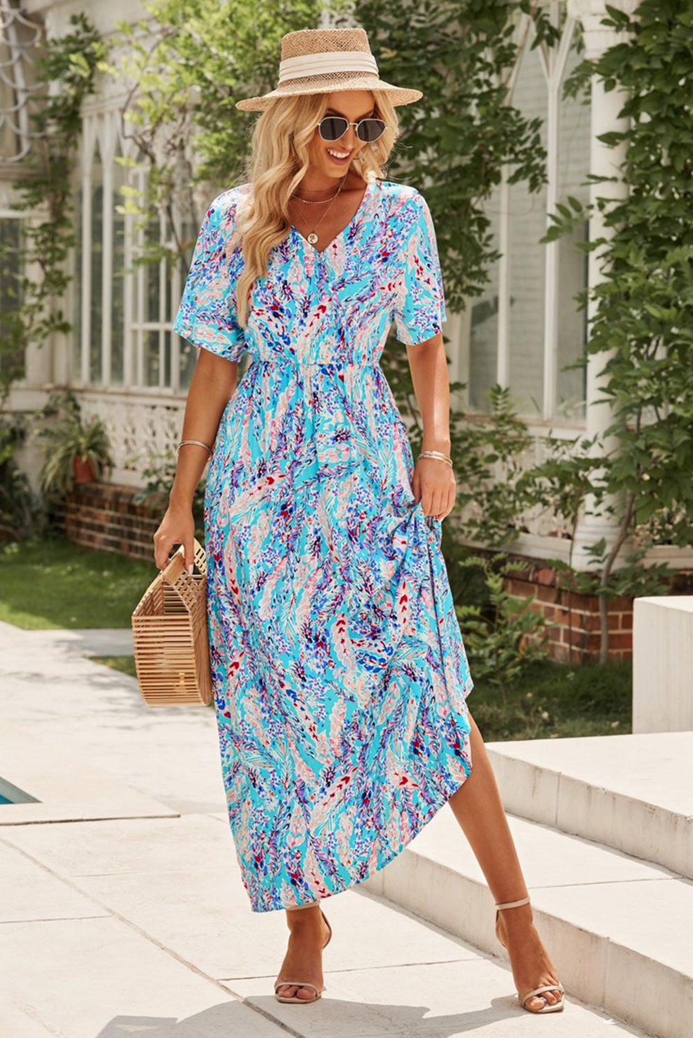 Multicolored V-neck maxi dress with short sleeves, chic and classy style, worn by a model outdoors.