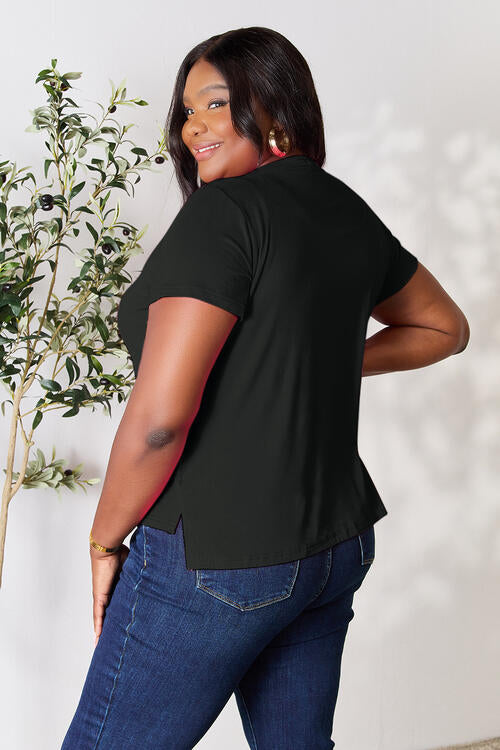 Basic Bae Full Size Round Neck Short Sleeve T-Shirt, slightly stretchy, opaque, black, worn by a person, side view.