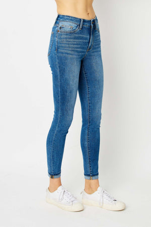 Judy Blue Full Size Cuffed Hem Skinny Jeans in blue, showcasing cuffed hem and slim fit, paired with white sneakers.