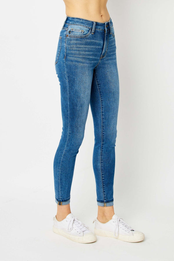 Judy Blue Full Size Cuffed Hem Skinny Jeans in blue, showcasing cuffed hem and slim fit, paired with white sneakers.