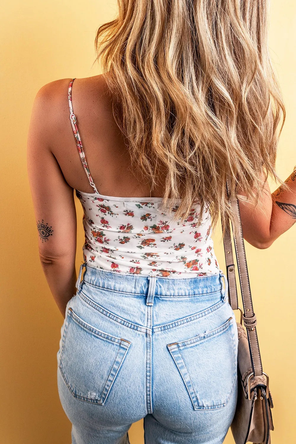 Floral frilled trim spaghetti strap bodysuit with jeans.