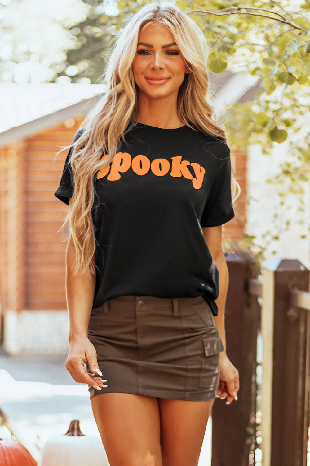 Spooky round neck short sleeve t-shirt with orange lettering.