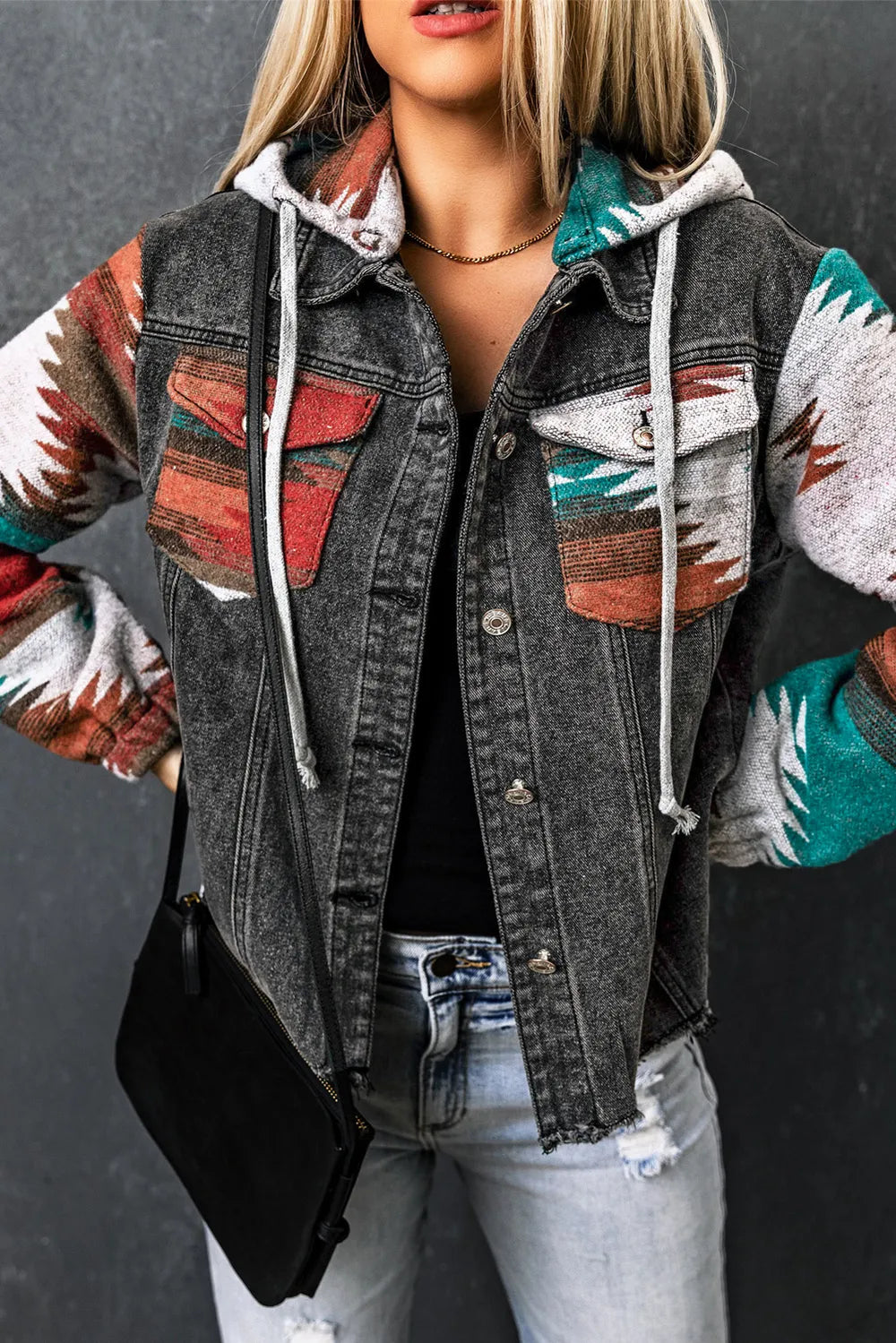 Drawstring hooded pocketed denim jacket with colorful patterned sleeves and front pockets.