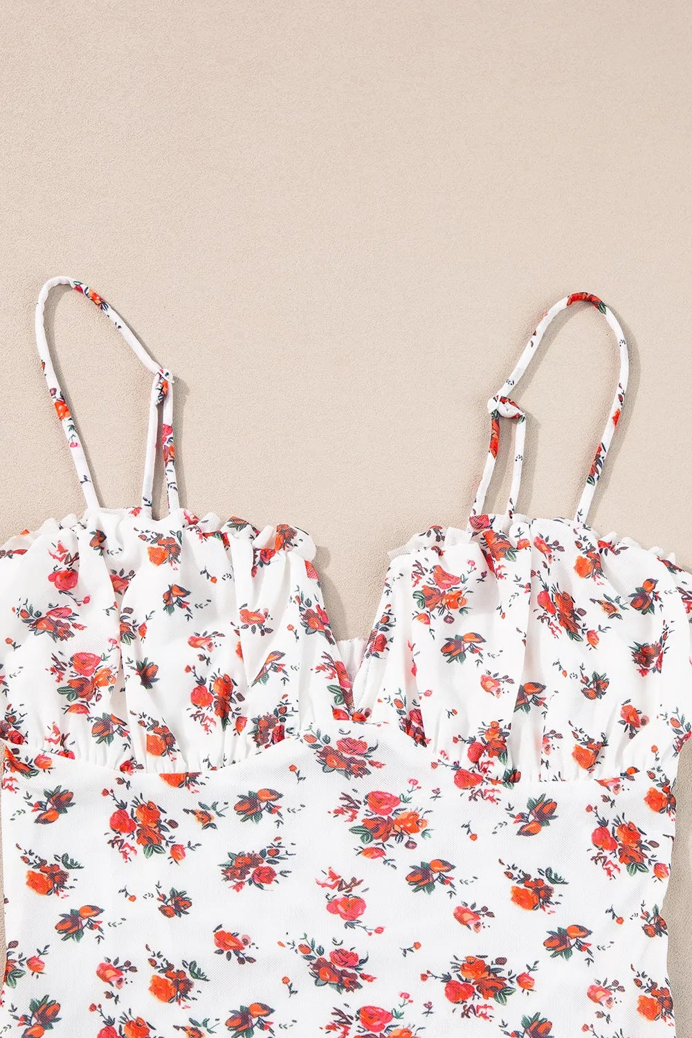 Floral frilled trim spaghetti straps bodysuit with floral pattern.