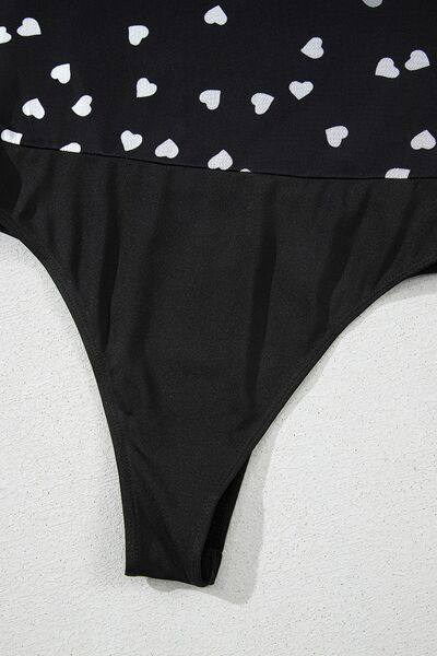 Heart square neck long sleeve bodysuit with lace detail and semi-sheer fabric.