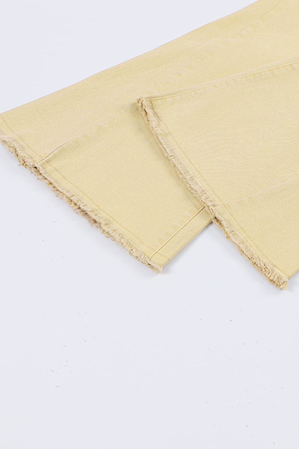 Raw edge mid waist flared jeans with raw hem and slight stretch.