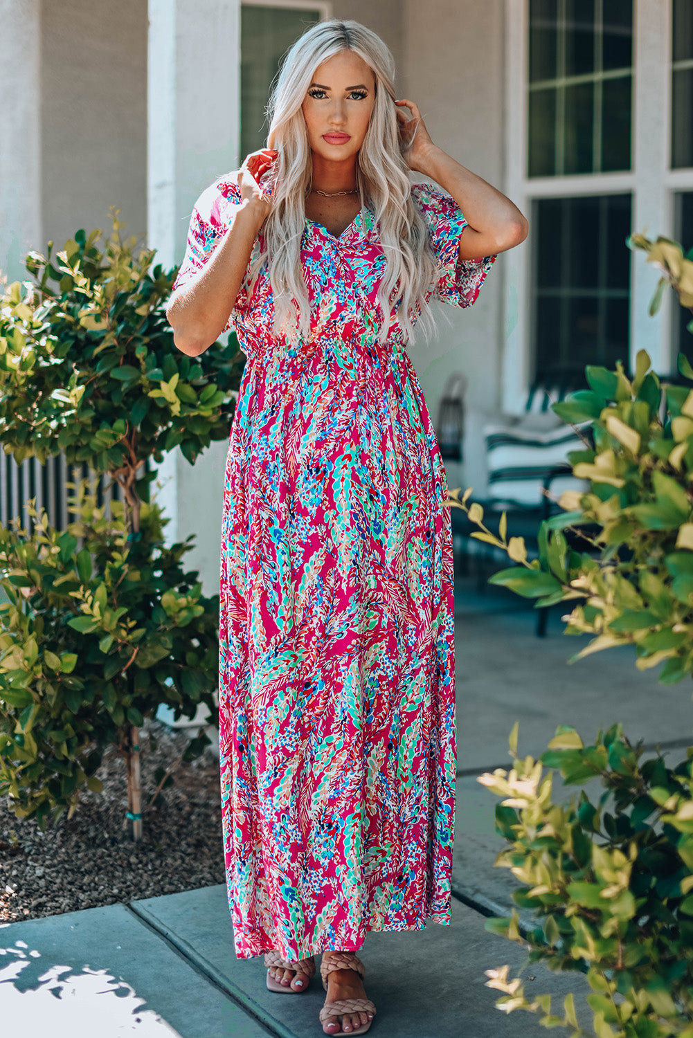 Multicolored V-neck maxi dress with short sleeves, chic style, and vibrant pattern.