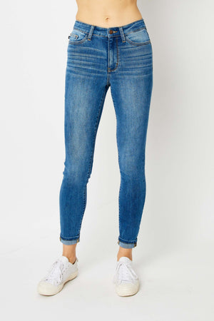 Judy Blue full size cuffed hem skinny jeans in blue denim on model.