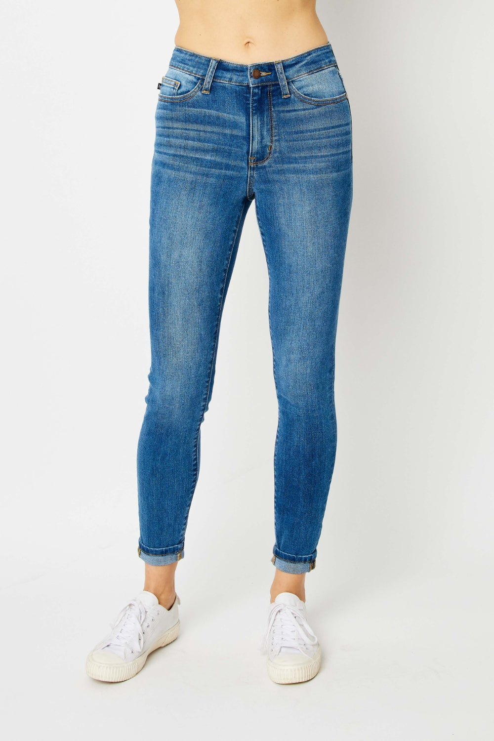 Judy Blue full size cuffed hem skinny jeans in blue denim on model.