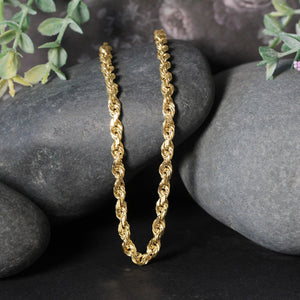 14k yellow gold solid diamond cut rope chain 5mm with lobster clasp displayed on black stones