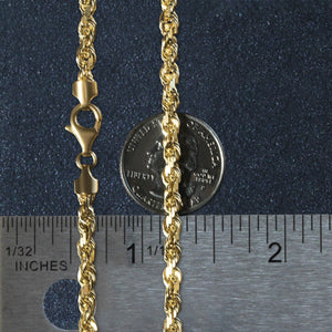 14k yellow gold solid diamond cut rope chain 5mm width with lobster clasp next to ruler and coin for scale