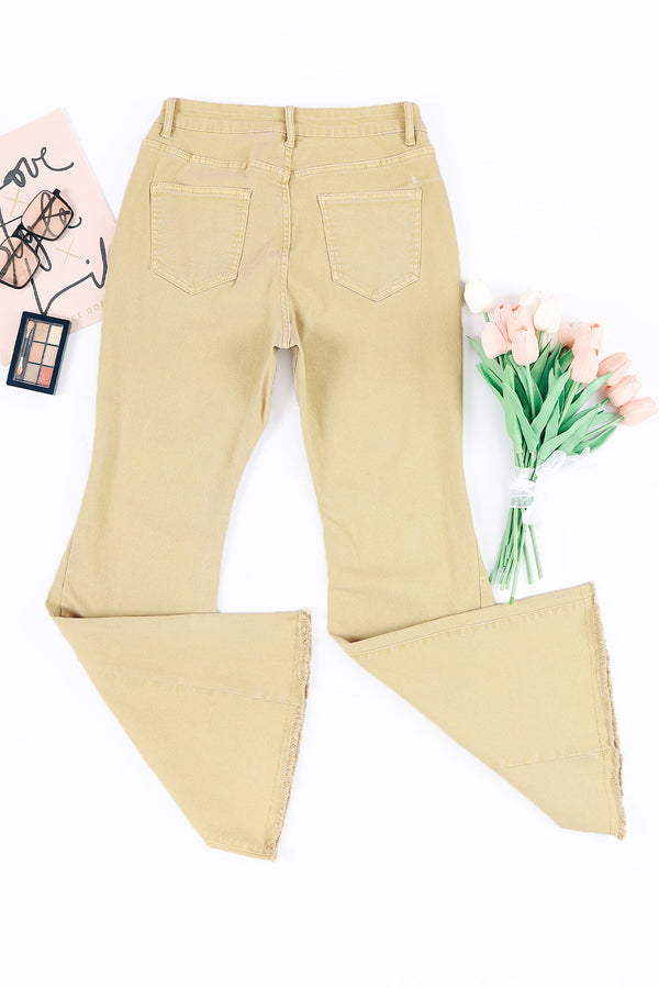Raw edge mid waist flared jeans with raw hem and pockets.