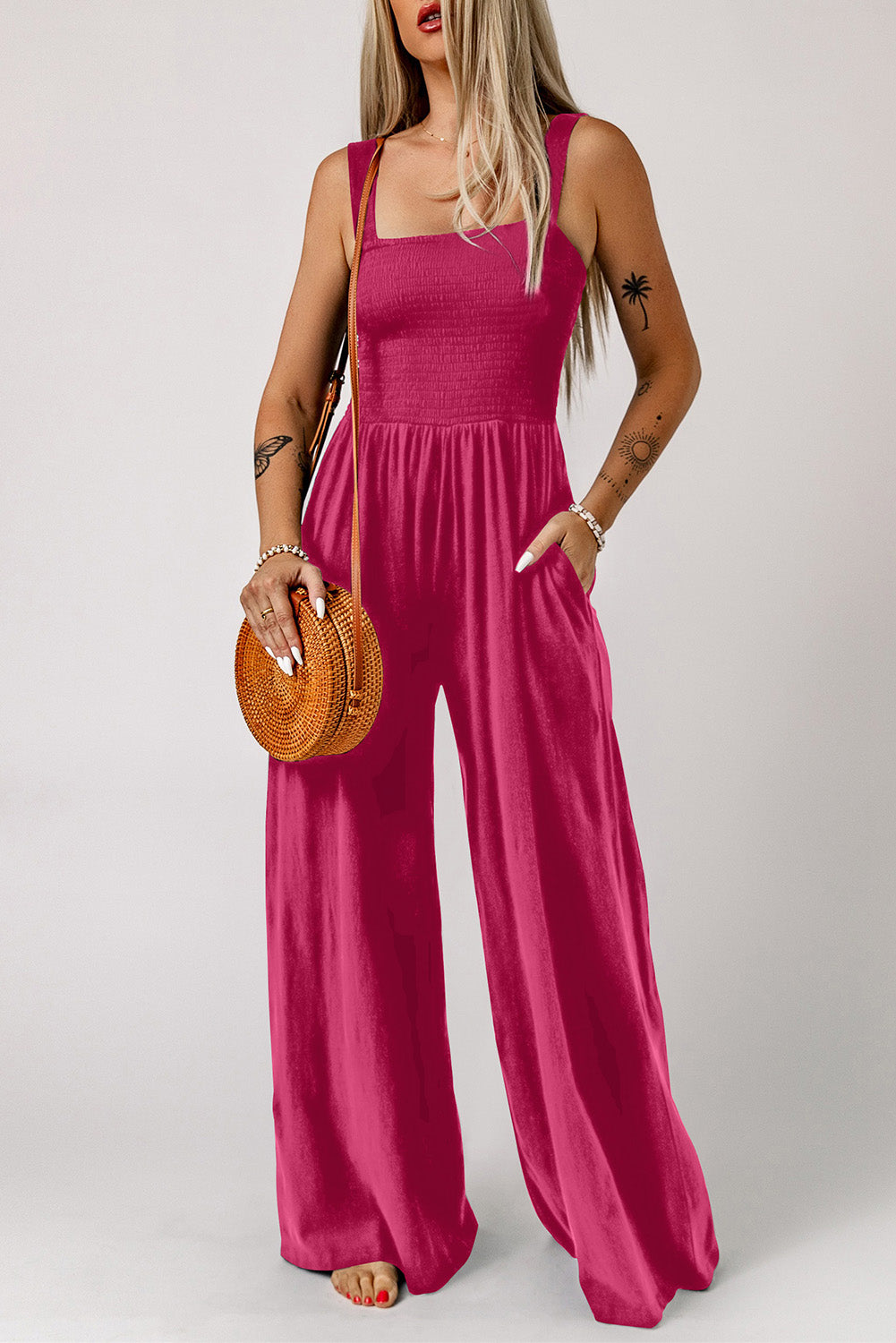 Smocked square neck wide leg jumpsuit with pockets in solid color.