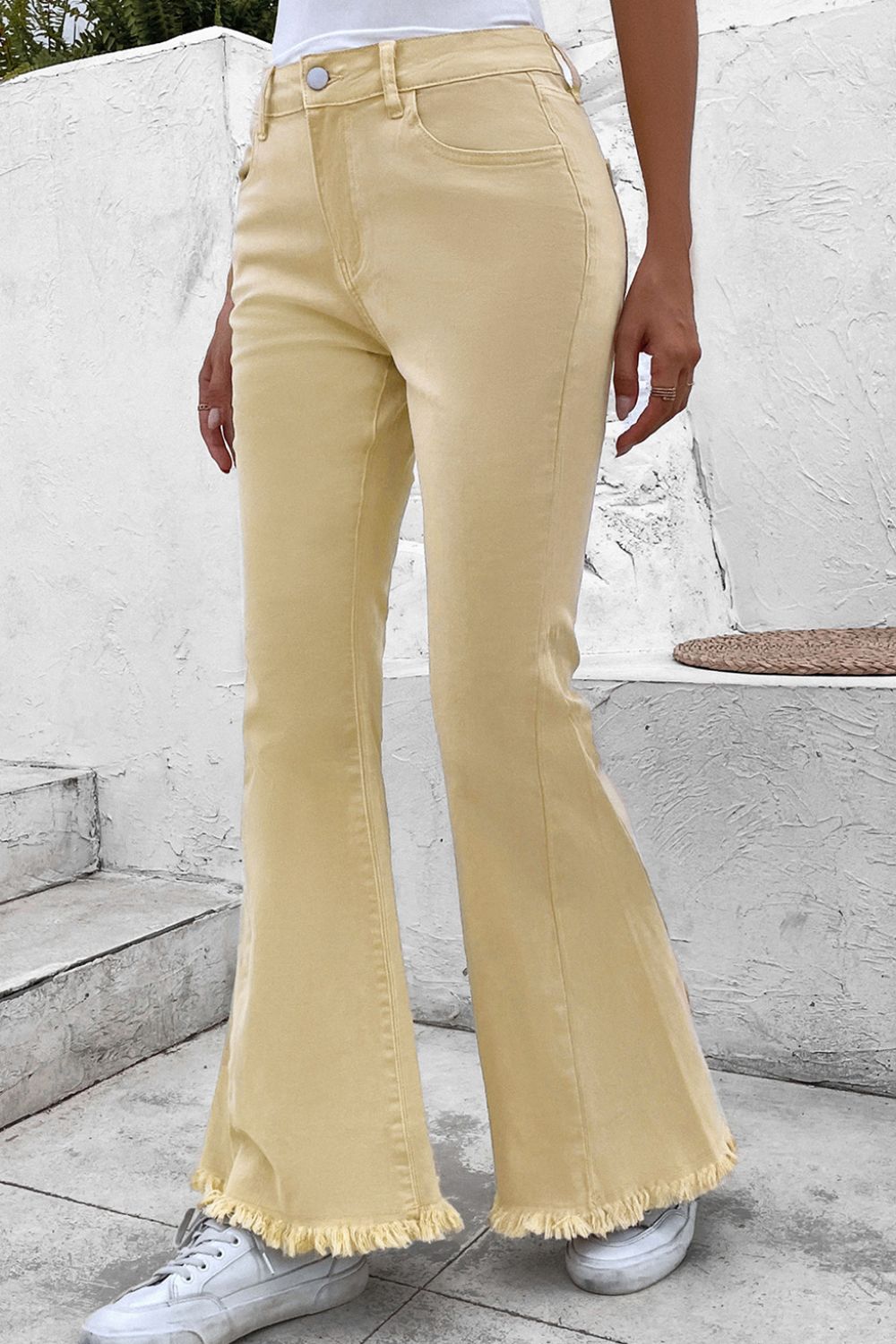 Raw edge mid waist flared jeans with pockets and raw hem.