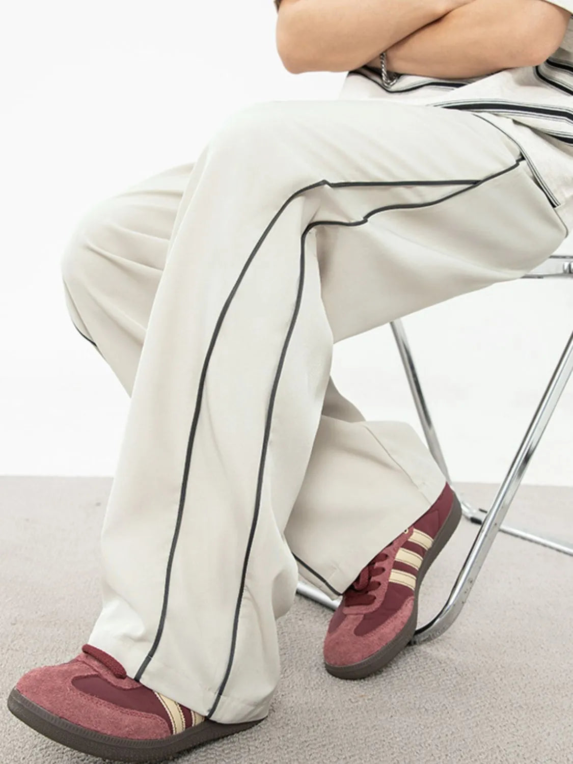 Men's contrast straight sweatpants with dark trim, worn casually, featuring basic style and polyester-spandex blend.