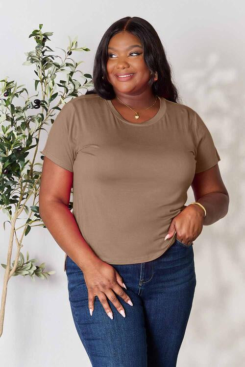 Basic Bae Full Size Round Neck Short Sleeve T-Shirt in brown, worn by a plus-size model, featuring basic style and slight stretch.