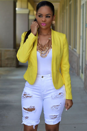 White denim destroyed bermuda shorts with relaxed fit and belt loops on model