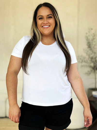Basic Bae Full Size Round Neck Short Sleeve T-Shirt in white, worn by a model smiling indoors.