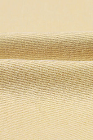 Fabric texture of Raw Edge Mid Waist Flared Jeans showing slightly stretchy material.
