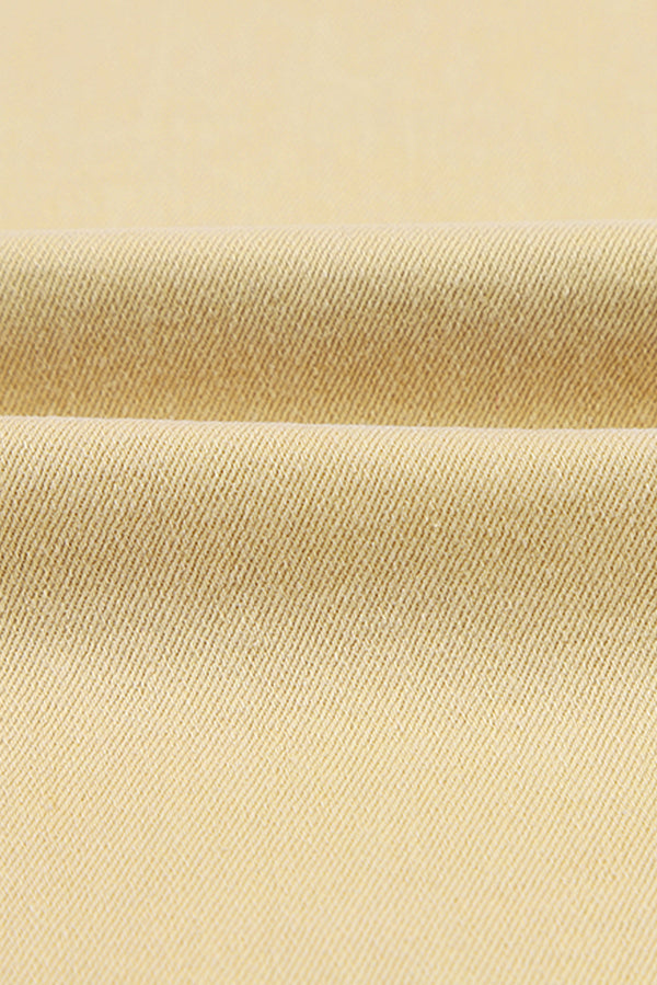 Fabric texture of Raw Edge Mid Waist Flared Jeans showing slightly stretchy material.