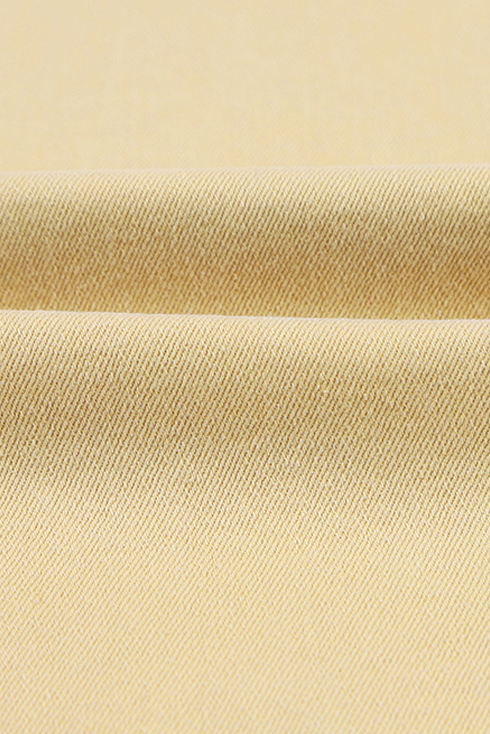 Fabric texture of Raw Edge Mid Waist Flared Jeans showing slightly stretchy material.
