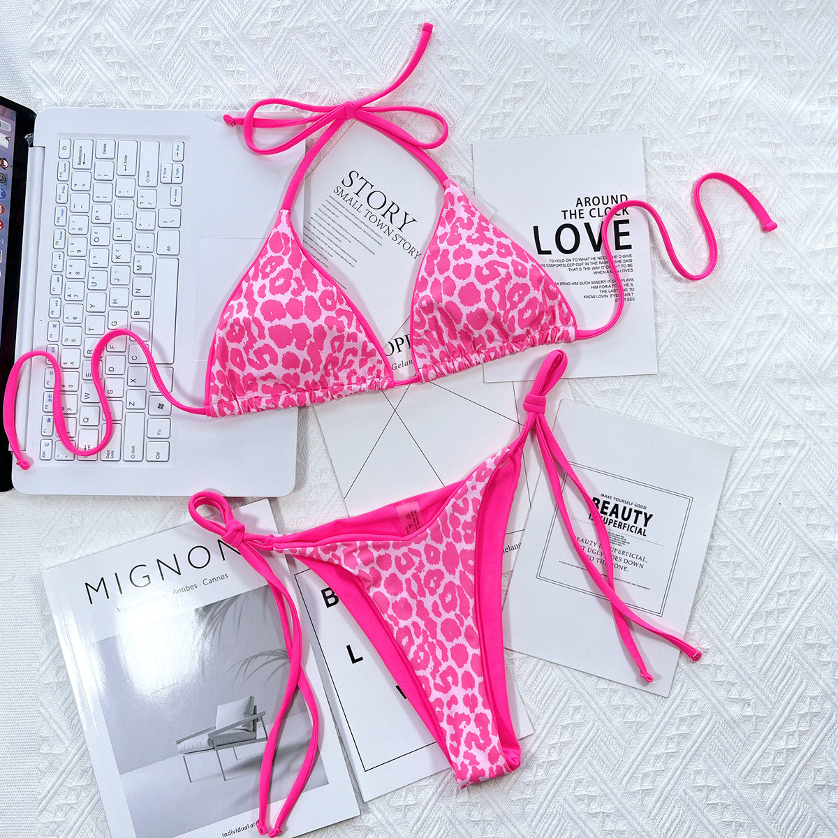 Leopard print halter neck tie side bikini set with removable padding on white background.