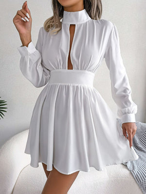 Cutout turtleneck A-line mini dress with long sleeves and keyhole neckline.