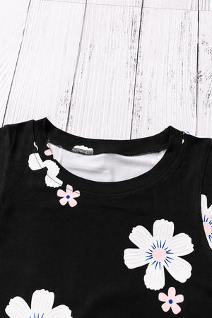 Printed side slit round neck tank with floral pattern on black fabric, sleeveless design.