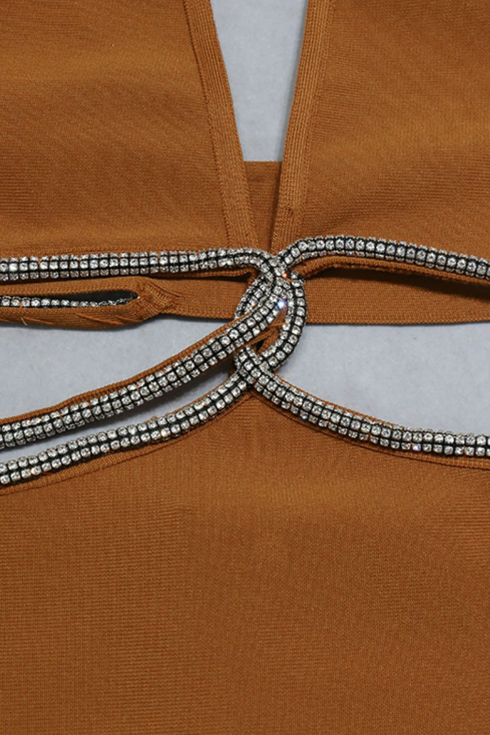 Rhinestone halter neck cutout slit midi dress in brown fabric with decorative rhinestones.