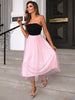 Two-tone spaghetti strap mesh dress, black bodice with pink flowing skirt, outdoors setting.