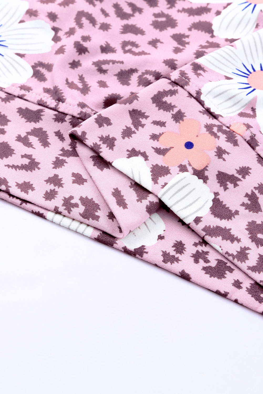 Printed side slit round neck tank with floral pattern, sleeveless casual style.