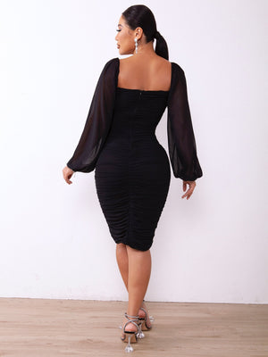 Chic black zip-back ruched bodycon dress with long sleeves and square neckline.
