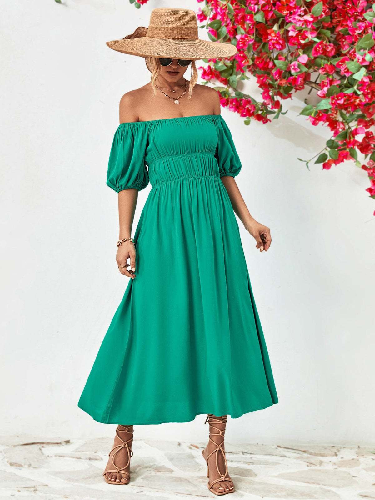 Off-shoulder green midi dress with balloon sleeves and A-line hem.