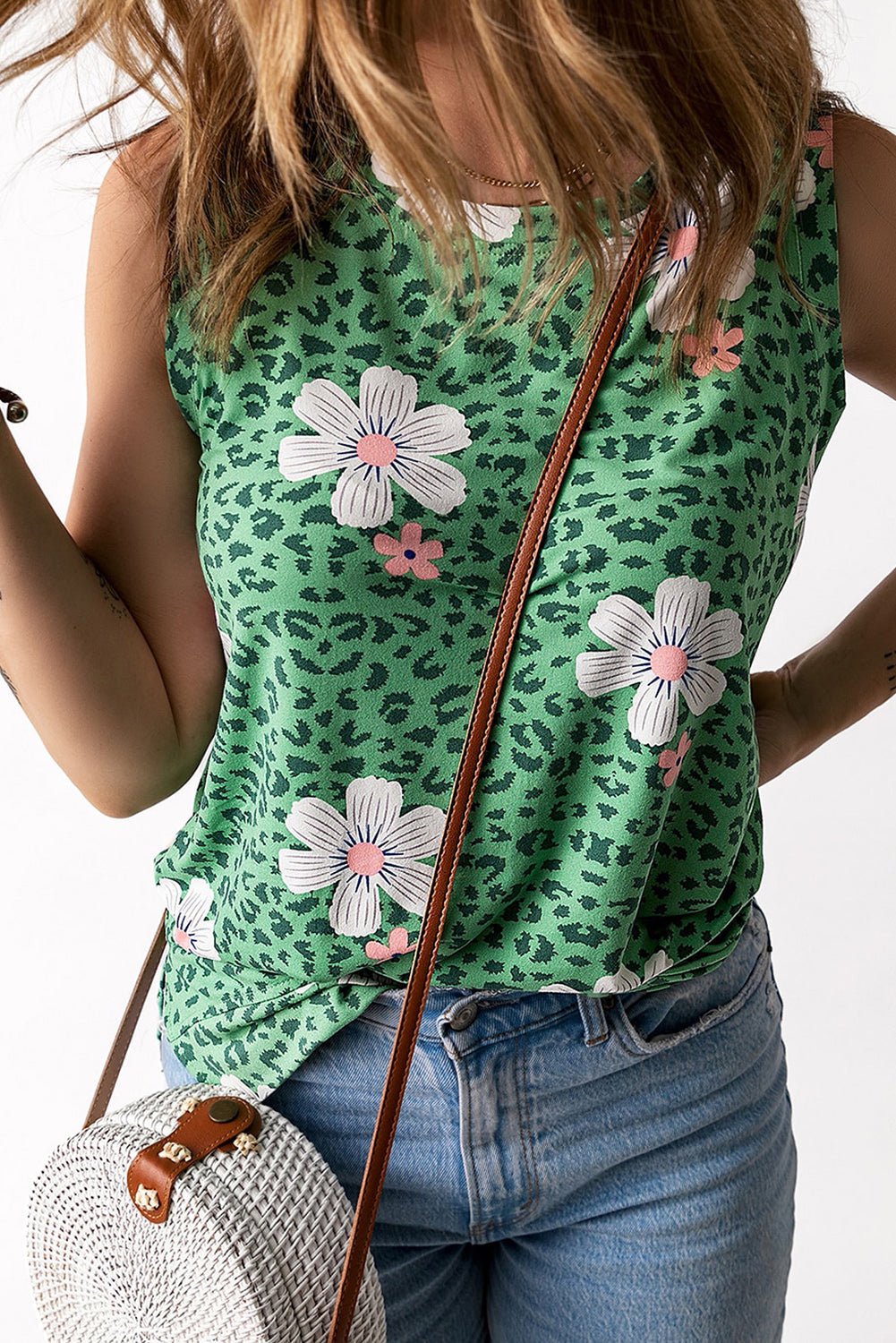 Printed side slit round neck tank with floral and leopard pattern, sleeveless design, and casual chic style.