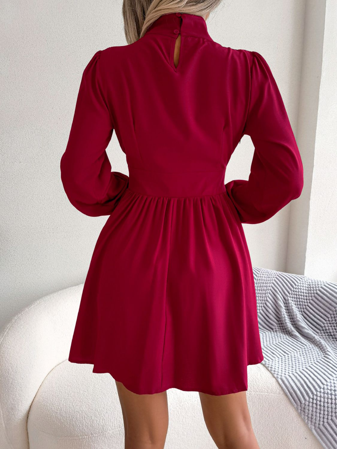 Cutout turtleneck A-line mini dress in solid red with keyhole neckline and long sleeves.