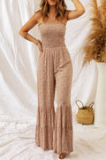 Floral spaghetti strap smocked wide leg jumpsuit with straight neckline, sleeveless design, and long length.
