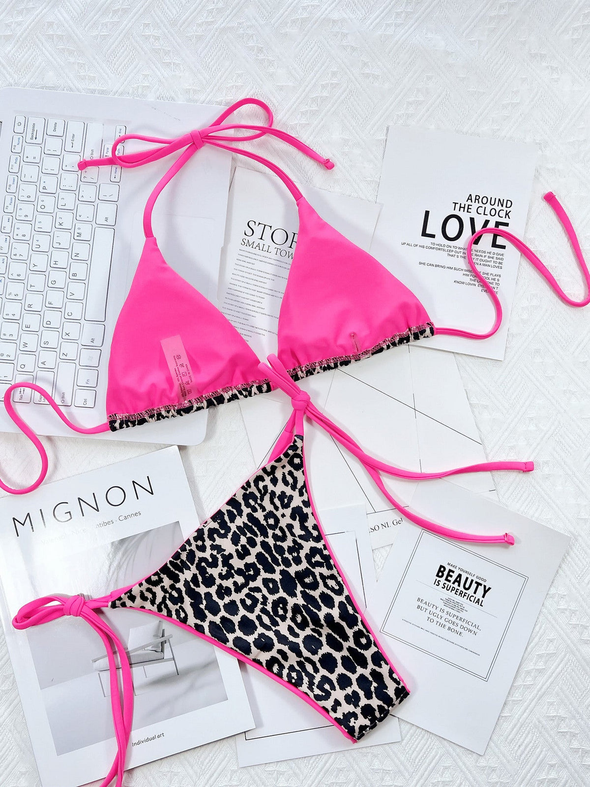 Leopard print halter neck bikini set with pink ties.