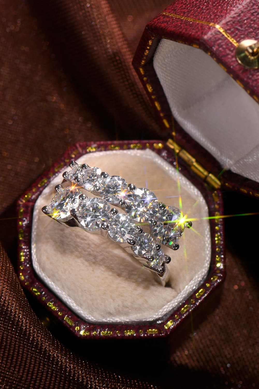 Moissanite jewelry ring in 925 sterling silver with platinum and 18K gold plating, displayed in a matching box.