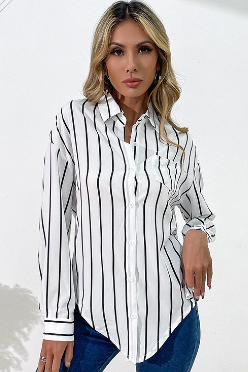 Vertical Stripes Button Down Shirt with long sleeves and asymmetrical hem.