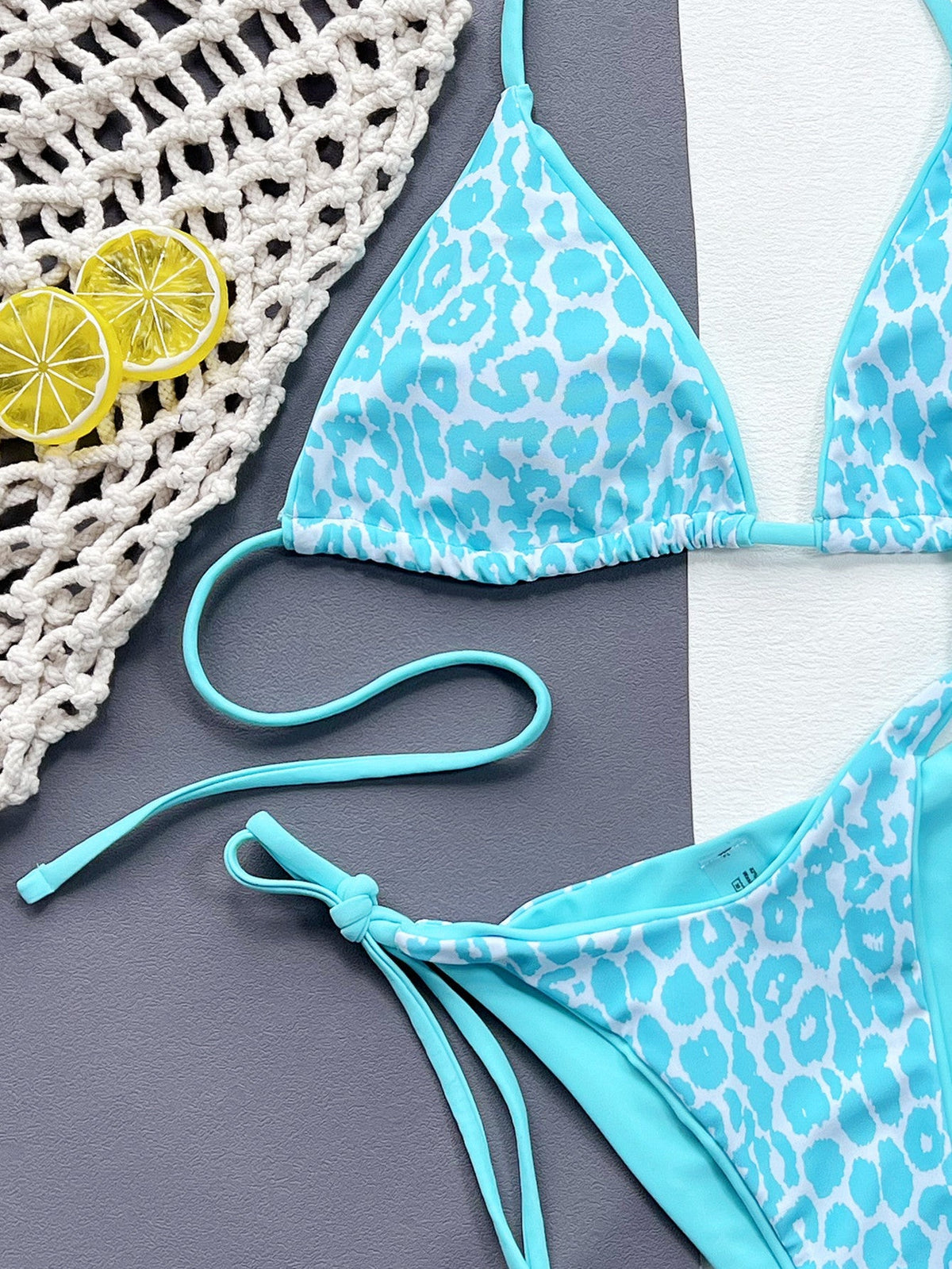 Leopard print halter neck tie side bikini set with removable padding.