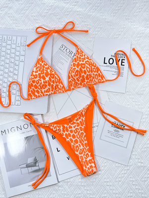 Leopard print halter neck tie side bikini set with removable padding.