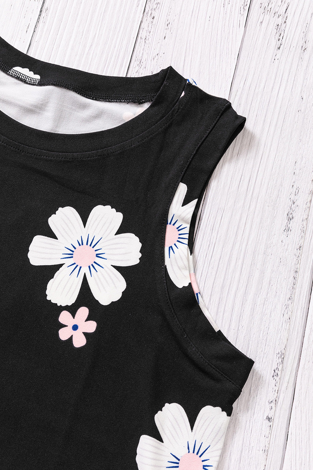 Printed side slit round neck tank, sleeveless with floral pattern.