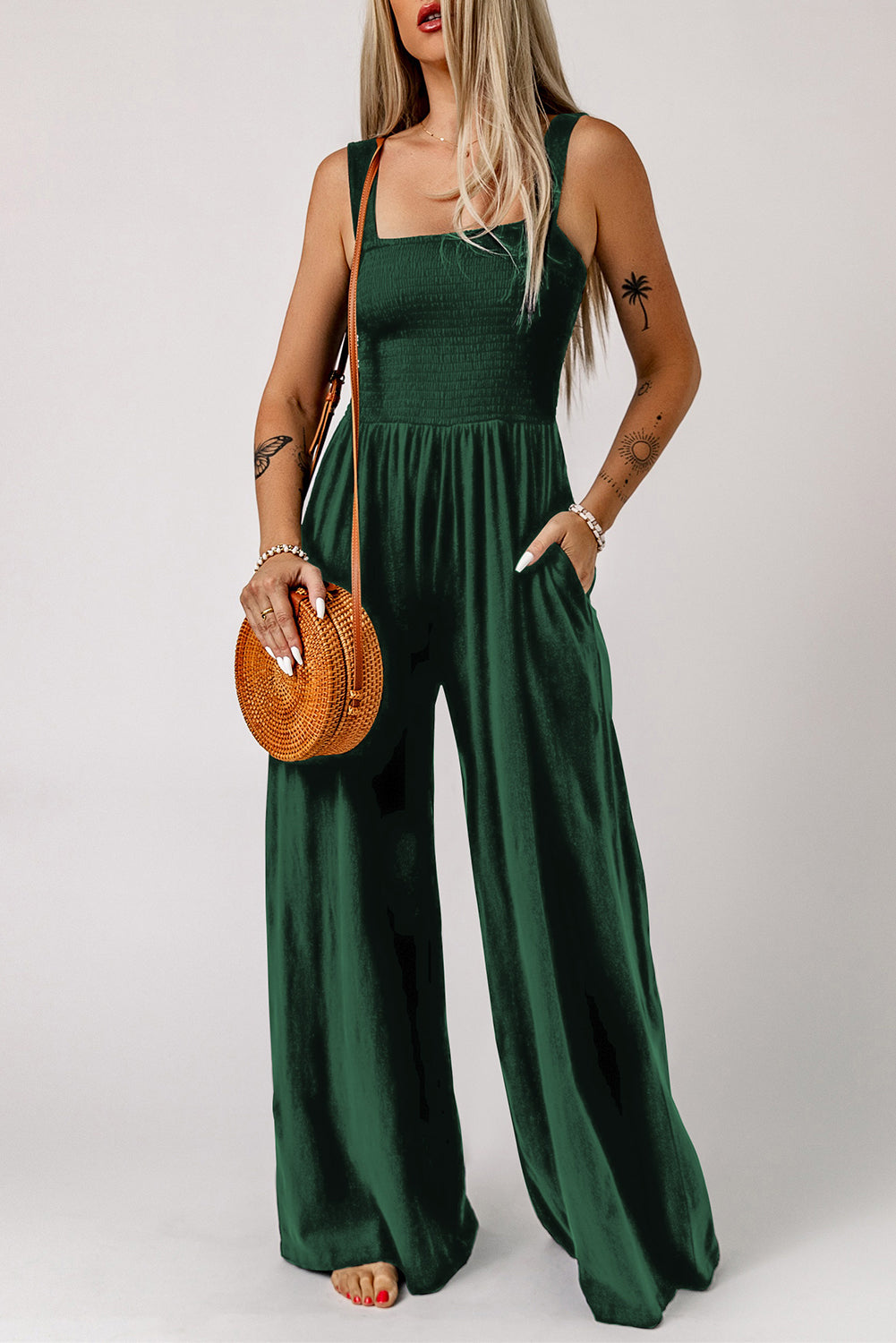 Smocked square neck wide leg jumpsuit with pockets, solid pattern, sleeveless style.