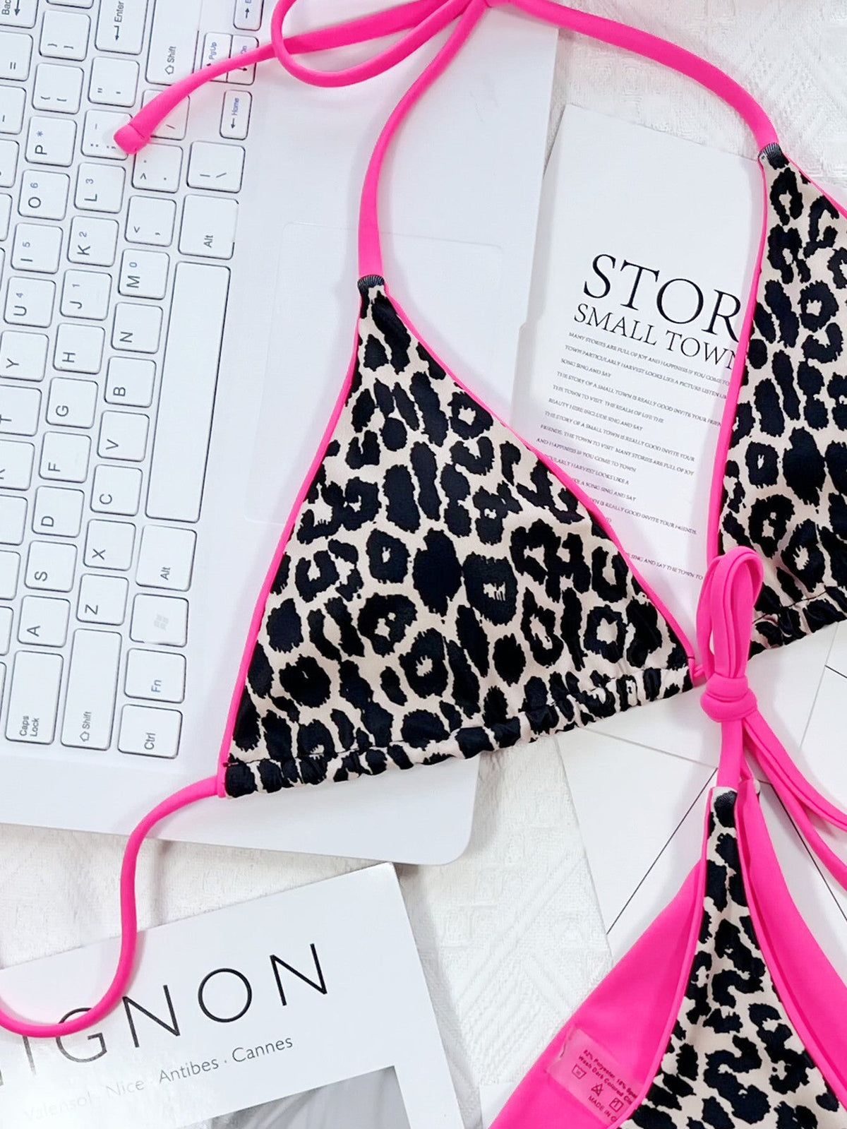 Leopard print halter neck tie side bikini set with pink trim.