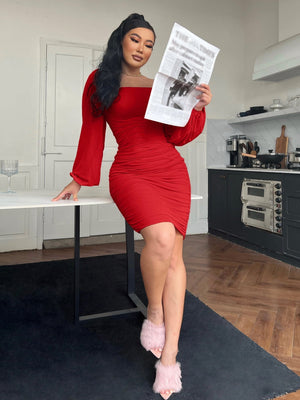 Knee-length red zip-back ruched bodycon dress with long sleeves and square neckline.